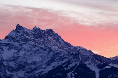 Scenic view of snowcapped mountains against sky during sunset