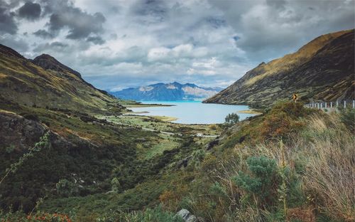 Scenic view of lake and mountains against sky