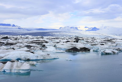 Frozen lake against sky during winter