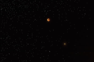 Low angle view of moon against sky at night