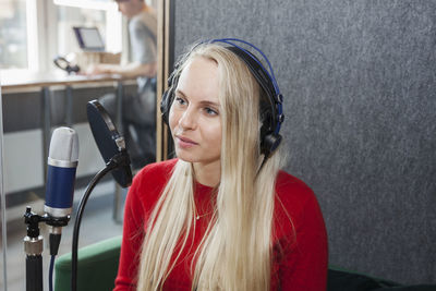 Smiling woman talking to microphone