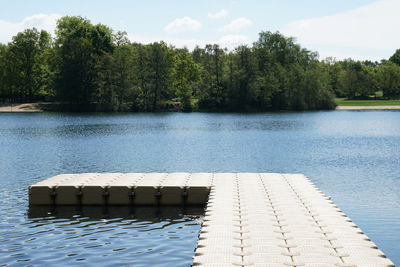 Scenic view of pier by lake against sky