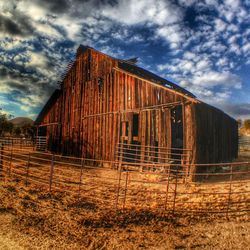 Abandoned house against cloudy sky