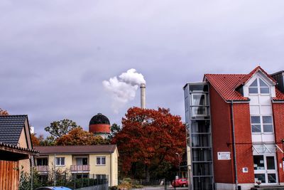 Smoke emitting from chimney against sky