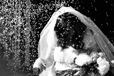 Close-up of woman with umbrella against water