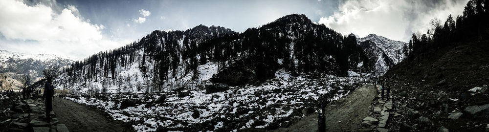 Panoramic view of snowcapped mountains against sky