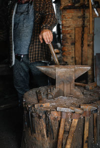 Man working on blacksmith workshop