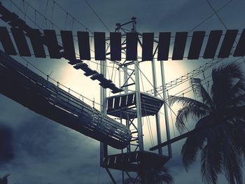 Low angle view of silhouette bridge against sky