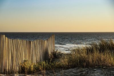 Scenic view of sea against clear sky during sunset