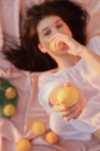 Directly above shot of woman holding lemon