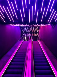 Low angle view of illuminated escalator