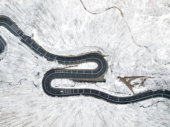 Aerial view of road amidst snow covered trees