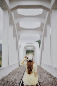 Rear view of a woman walking on bridge