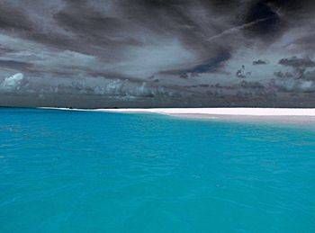 View of calm sea against cloudy sky