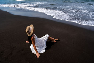 Rear view of woman walking on beach