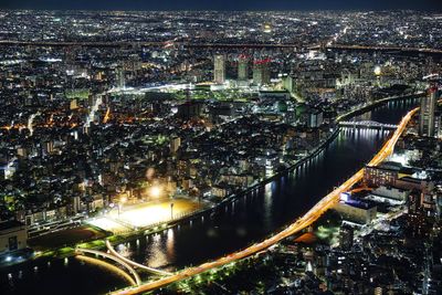 Night aerial panorama of brightly illuminated tokyo and sumida river