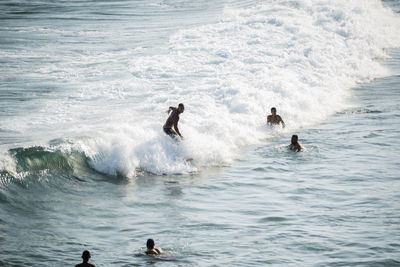 People bathing in the water at paciencia beach in salvador, bahia, brazil.