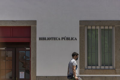 Full length of man standing by building