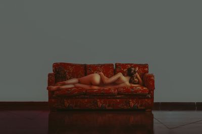 Red sofa on table against wall at home