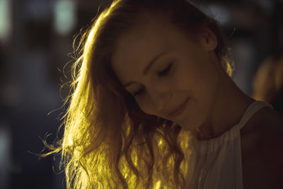 Close-up of smiling beautiful blond woman during sunset