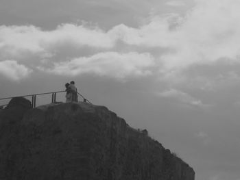 Low angle view of mountain against cloudy sky