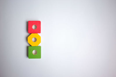 Multi colored toy blocks over white background