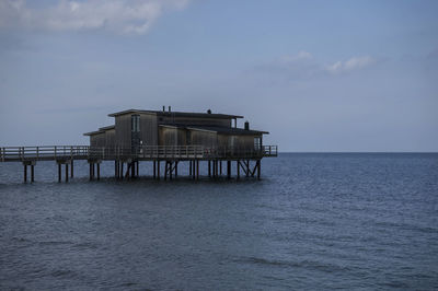 Built structure on sea against sky