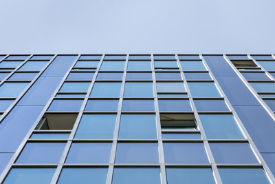 Low angle view of office building against clear sky