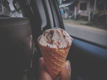 Person holding ice cream cone