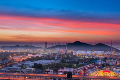 High angle view of illuminated cityscape against sky during sunset