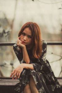 Portrait of beautiful woman sitting on seat