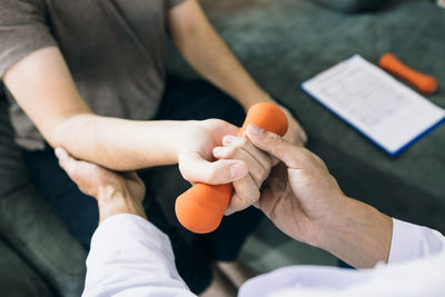 High angle view of woman holding dumbbells