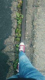 Low section of man standing on footpath