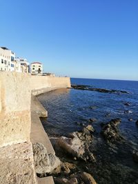 Scenic view of sea against clear blue sky