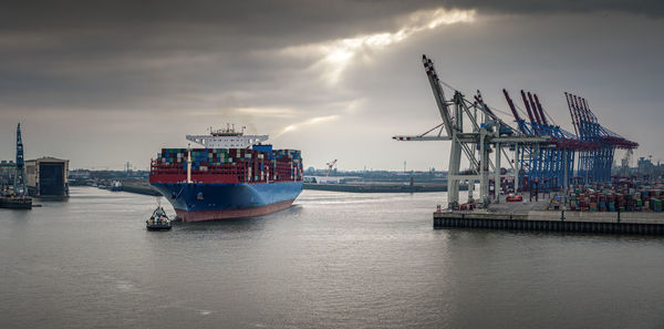 Commercial dock by sea against sky