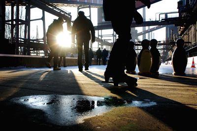 People walking on walkway on sunny day