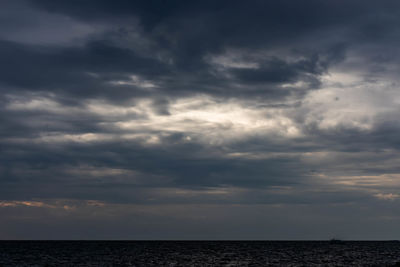 Scenic view of sea against cloudy sky
