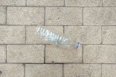 Close-up of water bottle on tiled floor