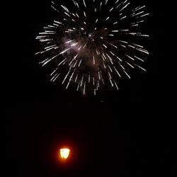 Low angle view of firework display at night