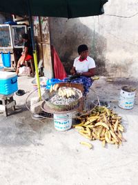 Man sitting at market stall