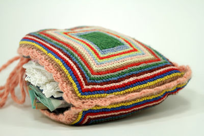 Close-up of colored object over white background