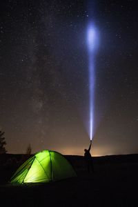 Silhouette of person against star field at night