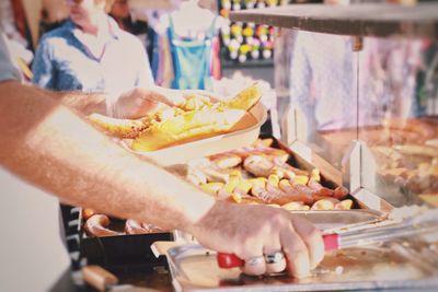 Close-up of man preparing food in market