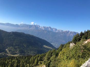 Scenic view of mountains against clear blue sky