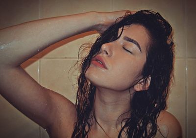 Portrait of young woman in bathtub