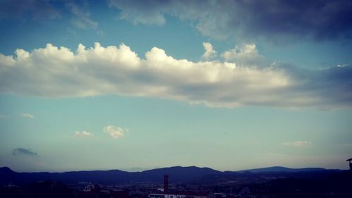 Mountain range against cloudy sky