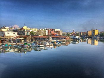 Boats in harbor with buildings in background