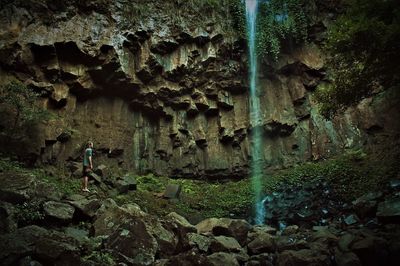 Man looking at waterfall