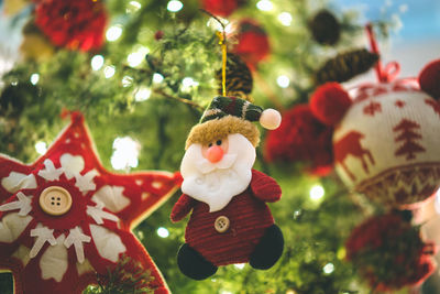 Close-up of christmas decorations hanging on tree