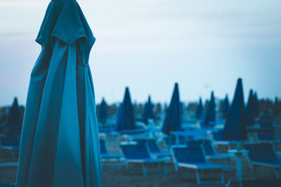 Close-up of chairs against blue sky